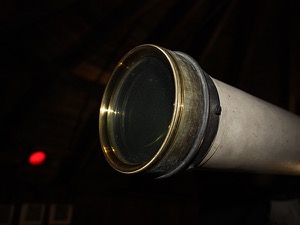 Telescope aperture with red observatory port-hole in background (to preserve night-vision)